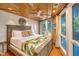 King-size bed, wood ceiling, large windows, and tropical bedding at 7 Dunecrest Trace, Seabrook Island, SC 29455