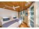 Two twin beds, wood ceiling, large windows, and blue bedding at 7 Dunecrest Trace, Seabrook Island, SC 29455