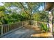 Deck with wooden railings, offering a peaceful, wooded view at 7 Dunecrest Trace, Seabrook Island, SC 29455