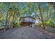Elevated treehouse home, surrounded by lush trees and offering a unique architectural design at 7 Dunecrest Trace, Seabrook Island, SC 29455