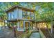 Elevated treehouse with wrap-around deck, surrounded by lush trees at 7 Dunecrest Trace, Seabrook Island, SC 29455