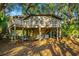 Treehouse home with wrap-around deck, providing scenic views of the surrounding landscape at 7 Dunecrest Trace, Seabrook Island, SC 29455