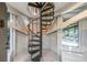 Modern black metal spiral staircase with a wood railing at 7 Dunecrest Trace, Seabrook Island, SC 29455