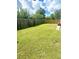 Large backyard with grassy area, wooden fence, and grill at 7315 Coopers Hawk Dr, Hanahan, SC 29410