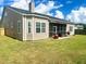 House's back with screened porch, patio, and grassy yard at 7315 Coopers Hawk Dr, Hanahan, SC 29410