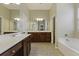 Double vanity bathroom with a large soaking tub at 7315 Coopers Hawk Dr, Hanahan, SC 29410