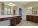 Bathroom boasts double vanity, tile flooring and large mirror at 7315 Coopers Hawk Dr, Hanahan, SC 29410