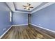 Bright bedroom with blue walls, hardwood floors and ceiling fan at 7315 Coopers Hawk Dr, Hanahan, SC 29410