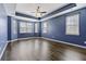 Spacious bedroom with blue walls, hardwood floors and multiple windows at 7315 Coopers Hawk Dr, Hanahan, SC 29410