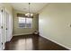 Bright dining room features hardwood floors and a chandelier at 7315 Coopers Hawk Dr, Hanahan, SC 29410