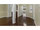 Hardwood floor hallway with built-in shelving and access to other rooms at 7315 Coopers Hawk Dr, Hanahan, SC 29410