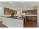Kitchen with dark wood cabinets, stainless steel appliances, and an island at 7315 Coopers Hawk Dr, Hanahan, SC 29410