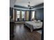 Spacious main bedroom with dark wood floors, blue walls, and a king-size bed at 7315 Coopers Hawk Dr, Hanahan, SC 29410