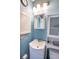 Clean bathroom with a pedestal sink, white vanity, and blue walls at 8419 Creekstone Ct, North Charleston, SC 29406