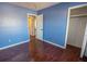 Bright bedroom with dark brown wood flooring and light blue walls at 8419 Creekstone Ct, North Charleston, SC 29406