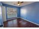 Bright bedroom with dark brown wood flooring and light blue walls at 8419 Creekstone Ct, North Charleston, SC 29406