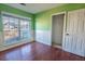Empty bedroom with wood flooring, green walls, and white wainscoting at 8419 Creekstone Ct, North Charleston, SC 29406