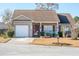 Tan house with brown roof, white garage door, and small front porch at 8419 Creekstone Ct, North Charleston, SC 29406