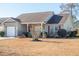 Tan house with brown roof, white garage door, and small front porch at 8419 Creekstone Ct, North Charleston, SC 29406