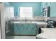 Kitchen with teal cabinets, stainless steel appliances, and white countertops at 8419 Creekstone Ct, North Charleston, SC 29406