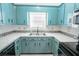 Kitchen with teal cabinets, stainless steel appliances, and white countertops at 8419 Creekstone Ct, North Charleston, SC 29406
