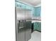 Stainless steel refrigerator in teal kitchen at 8419 Creekstone Ct, North Charleston, SC 29406