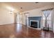 Living room with fireplace, hardwood floors, and sliding glass doors at 8419 Creekstone Ct, North Charleston, SC 29406