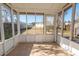 Bright screened porch with tiled floor and backyard view at 8419 Creekstone Ct, North Charleston, SC 29406