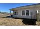 Rear view of house with gray siding, windows, and patio at 962 Dusk Dr, Summerville, SC 29486
