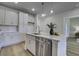 Kitchen island with quartz countertop, stainless steel dishwasher, and white cabinets at 962 Dusk Dr, Summerville, SC 29486
