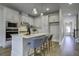 Open concept kitchen with white cabinets, island with seating, and hardwood floors at 962 Dusk Dr, Summerville, SC 29486