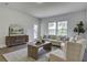 Spacious living room with beige sofa, wooden coffee table, and access to backyard at 962 Dusk Dr, Summerville, SC 29486
