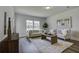 Bright living room with a beige couch, wooden coffee table, and large windows at 962 Dusk Dr, Summerville, SC 29486