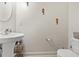 Clean bathroom with pedestal sink, toilet and seahorse decor at 9632 Scarborough Ct, Summerville, SC 29485