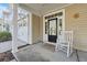 Inviting front porch with rocking chair, entrance, and attached garage at 9632 Scarborough Ct, Summerville, SC 29485