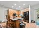 Modern kitchen with light wood cabinets, black appliances, and an island at 9632 Scarborough Ct, Summerville, SC 29485