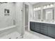 Modern bathroom with marble shower, dual vanity, and gray cabinets at 119 Leeward Lndg, Summerville, SC 29486
