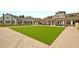 Expansive green lawn with modern clubhouse in background at 119 Leeward Lndg, Summerville, SC 29486
