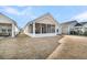 Tan house exterior with screened porch and grassy backyard at 119 Leeward Lndg, Summerville, SC 29486