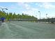Full-size tennis court with surrounding fence at 119 Leeward Lndg, Summerville, SC 29486
