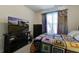Bright bedroom featuring a TV, window, and colorful bedspread at 1209 Hammrick Ln, Johns Island, SC 29455