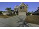 Two-story house with a two-car garage and palm trees at 1209 Hammrick Ln, Johns Island, SC 29455