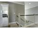 Upstairs hallway with gray walls and white railing leading to lower level at 1209 Hammrick Ln, Johns Island, SC 29455