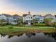 Aerial view of charming house with water feature and landscaped surroundings at 1583 Paradise Lake Dr, Mount Pleasant, SC 29464