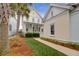 Quaint yellow house exterior with walkway, palm trees, and manicured lawn at 1583 Paradise Lake Dr, Mount Pleasant, SC 29464