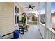 Inviting front porch features rocking chairs and a ceiling fan at 1583 Paradise Lake Dr, Mount Pleasant, SC 29464