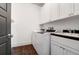 Laundry room with white cabinets, washer, dryer, and a utility sink at 1583 Paradise Lake Dr, Mount Pleasant, SC 29464