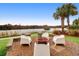 Brick patio with fire pit and seating overlooking a lake at 1583 Paradise Lake Dr, Mount Pleasant, SC 29464
