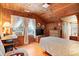 Cozy bedroom with wood walls, window, and twin bed at 2028 Coker Ave, Charleston, SC 29412