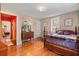 Spacious bedroom with hardwood floors, a large bed, and antique furniture at 2028 Coker Ave, Charleston, SC 29412